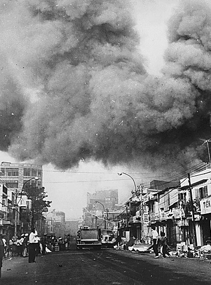 Black smoke covers areas of Saigon, and fire trucks rush to the scenes of fires set during attacks by the Viet Cong during the festive Tet holiday period in 1968.