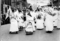 Women Holding American Flags while protesting. One of them is Pushing a Stroller